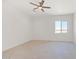 Expansive bedroom with tile flooring and a bright window, offering views of the outdoors at 28615 N 257Th Dr, Wittmann, AZ 85361