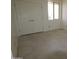 Bedroom with tile flooring, a window, and double doors at 28615 N 257Th Dr, Wittmann, AZ 85361