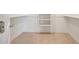 Bright walk-in closet featuring built-in shelving and neutral flooring at 28615 N 257Th Dr, Wittmann, AZ 85361