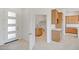 Bright entryway with modern front door leading to laundry room with sink and storage at 28615 N 257Th Dr, Wittmann, AZ 85361