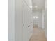 Bright hallway with tile floors, leading to the bathroom with tiled shower and tub at 28615 N 257Th Dr, Wittmann, AZ 85361