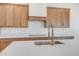 Open concept kitchen with modern fixtures, stainless appliances, and quartz countertops at 28615 N 257Th Dr, Wittmann, AZ 85361