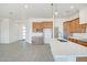 Open concept kitchen with white walls, modern island and shaker cabinets at 28615 N 257Th Dr, Wittmann, AZ 85361