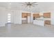 Open concept kitchen with white walls, modern ceiling fan and shaker cabinets at 28615 N 257Th Dr, Wittmann, AZ 85361