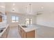 Bright kitchen with shaker cabinets, quartz countertops, stainless steel faucet and island at 28615 N 257Th Dr, Wittmann, AZ 85361