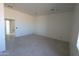 Spacious living room with tile flooring and a large window at 28615 N 257Th Dr, Wittmann, AZ 85361