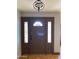 Front entry with a dark brown door and sidelights at 3506 W Yucca St, Phoenix, AZ 85029