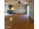 Open living room with hardwood floors and a view into the kitchen at 3506 W Yucca St, Phoenix, AZ 85029