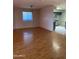 Open living area with hardwood floors and kitchen access at 3506 W Yucca St, Phoenix, AZ 85029