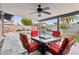 This outdoor patio with seating features an outdoor ceiling fan overlooking the pool at 3519 E De Poe Ln, Phoenix, AZ 85028