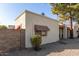 Side view of tan stucco condo showing a walkway and landscaping at 3535 W Monte Cristo Ave # 101, Phoenix, AZ 85053