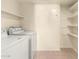 Laundry area with washer, dryer, and shelving at 3535 W Monte Cristo Ave # 101, Phoenix, AZ 85053
