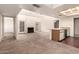 High-ceilinged living room with kitchen, fireplace, and access to patio at 3535 W Monte Cristo Ave # 101, Phoenix, AZ 85053