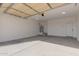 Garage with open overhead door and white walls at 37144 W Encinas Ln, Tonopah, AZ 85354