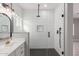 Modern shower with subway tile and hexagon floor tile at 37144 W Encinas Ln, Tonopah, AZ 85354