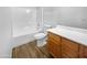 Bathroom with wood-look floors, white bathtub and vanity at 40551 N Jodi Dr, San Tan Valley, AZ 85140
