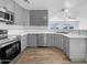 Modern kitchen with gray cabinets and stainless steel appliances at 40551 N Jodi Dr, San Tan Valley, AZ 85140