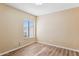 Simple bedroom with wood-look floors and window at 413 W Beverly Ln, Phoenix, AZ 85023