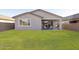 A well-maintained backyard featuring a patio with chairs, a grill, and a spacious lawn at 4342 E Enmark Dr, San Tan Valley, AZ 85143