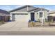 Charming single-story home featuring a two-car garage and inviting front entrance with landscaped yard at 4342 E Enmark Dr, San Tan Valley, AZ 85143