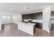 Bright open kitchen with modern appliances, white countertops, and wood-look flooring at 4342 E Enmark Dr, San Tan Valley, AZ 85143