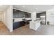 Modern kitchen with stainless steel appliances, dark cabinets, and a bright white island at 4342 E Enmark Dr, San Tan Valley, AZ 85143
