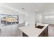 Bright living space with large sliding glass doors, and hardwood floors with a kitchen island at 4342 E Enmark Dr, San Tan Valley, AZ 85143