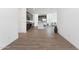 Bright, open-concept living space with hardwood floors, flowing into a modern kitchen with stainless steel appliances at 4342 E Enmark Dr, San Tan Valley, AZ 85143