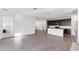 Spacious living room with hardwood floors and open layout with a kitchen in the background at 4342 E Enmark Dr, San Tan Valley, AZ 85143
