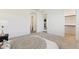 Bright, spacious bedroom with plush carpeting and view to ensuite bathroom and kitchen at 4342 E Enmark Dr, San Tan Valley, AZ 85143