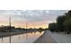 Evening view of canal walkway and city skyline at 4950 N Miller Rd # 130, Scottsdale, AZ 85251