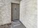 Unit entry with gray door and welcome mat at 4950 N Miller Rd # 130, Scottsdale, AZ 85251