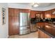 Stainless steel appliances and ample wood cabinetry in this kitchen at 4950 N Miller Rd # 130, Scottsdale, AZ 85251