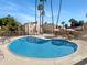 Community pool with surrounding lounge chairs and patio at 4950 N Miller Rd # 130, Scottsdale, AZ 85251