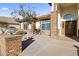 Close up of front entrance with brick column, paved walkway and mature shade tree at 5345 E Mclellan Rd # 89, Mesa, AZ 85205