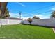 Backyard featuring artificial green grass and a tall white fence at 545 W Windsor Ave, Phoenix, AZ 85003