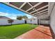 The backyard features manicured green grass and a covered patio area at 545 W Windsor Ave, Phoenix, AZ 85003