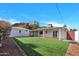 Large backyard with lush green grass and a covered patio, perfect for outdoor entertaining at 545 W Windsor Ave, Phoenix, AZ 85003