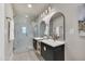 Elegant bathroom featuring dual sinks, modern fixtures, and a glass-enclosed shower at 545 W Windsor Ave, Phoenix, AZ 85003