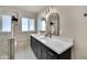 Bright bathroom with dual sinks, white counters, dark cabinets, and modern lighting at 545 W Windsor Ave, Phoenix, AZ 85003