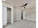 Bright bedroom with a ceiling fan, closet with sliding doors and neutral carpet at 545 W Windsor Ave, Phoenix, AZ 85003