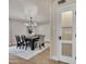 Dining room with wood table and chairs, modern chandelier, and doorway with glass at 545 W Windsor Ave, Phoenix, AZ 85003