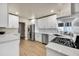 Updated kitchen with white cabinets, stainless steel appliances, and modern finishes at 545 W Windsor Ave, Phoenix, AZ 85003