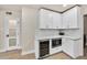 Additional kitchen storage with a wine cooler, microwave and white cabinets at 545 W Windsor Ave, Phoenix, AZ 85003