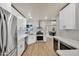 Bright kitchen featuring white cabinets, stainless steel appliances, and wood flooring at 545 W Windsor Ave, Phoenix, AZ 85003