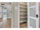 Organized pantry with open shelves, white door and modern hardware at 545 W Windsor Ave, Phoenix, AZ 85003