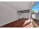 Covered patio leading to a gated garage door and brick walls at 545 W Windsor Ave, Phoenix, AZ 85003