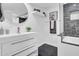 Bathroom with white vanity, walk-in shower, and dark marble tile at 6502 N Central Ave # B104, Phoenix, AZ 85012