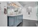 Elegant bathroom with dual vanity, marble countertop, and blue cabinets at 6502 N Central Ave # B104, Phoenix, AZ 85012