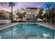 Inviting pool with a modern building and palm trees in the background at 6502 N Central Ave # B104, Phoenix, AZ 85012